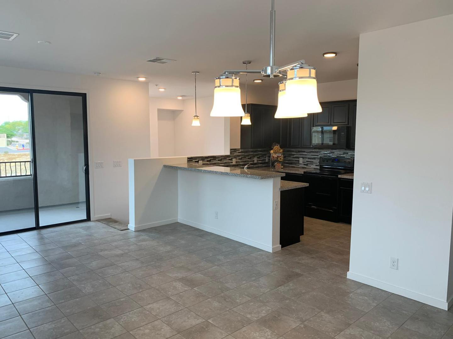 3900 East Baseline Road, Unit 118 Phoenix, AZ 85042 - Photo 18 of 32 a view of a kitchen with a sink and chandelier