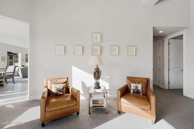 a view of a patio with table and chairs and floor to ceiling window