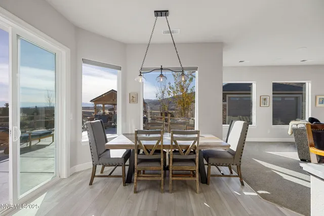 a view of a patio with table and chairs a barbeque with wooden fence