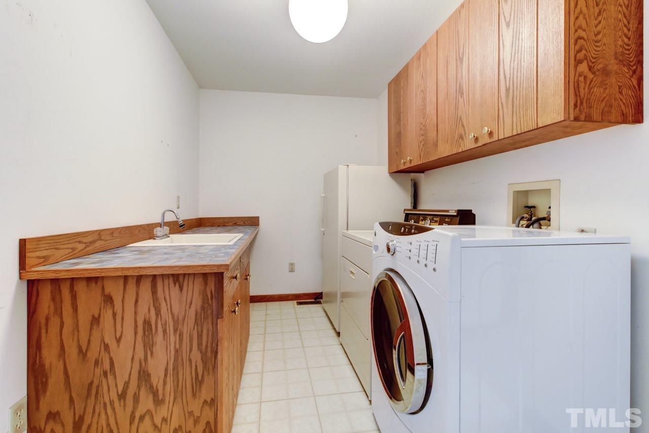 1600 Center Grove Church Road Moncure, NC 27559 - Photo 15 of 25 All appliances stay including the freezer. Large 1st floor utility room offers a large sink and is right off the garage!