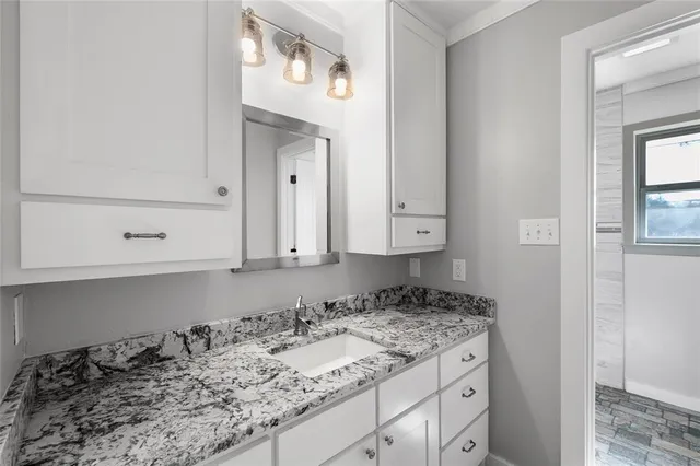 a view of a sink and cabinets