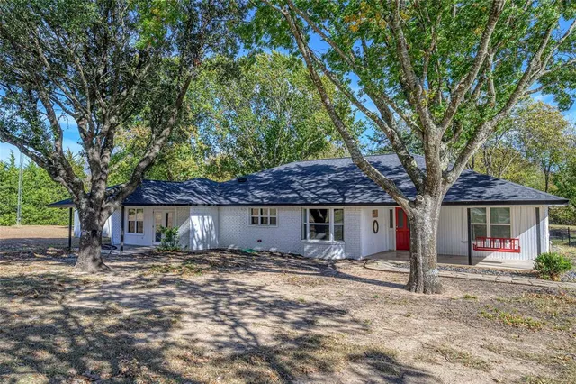 a house with a tree in front of it