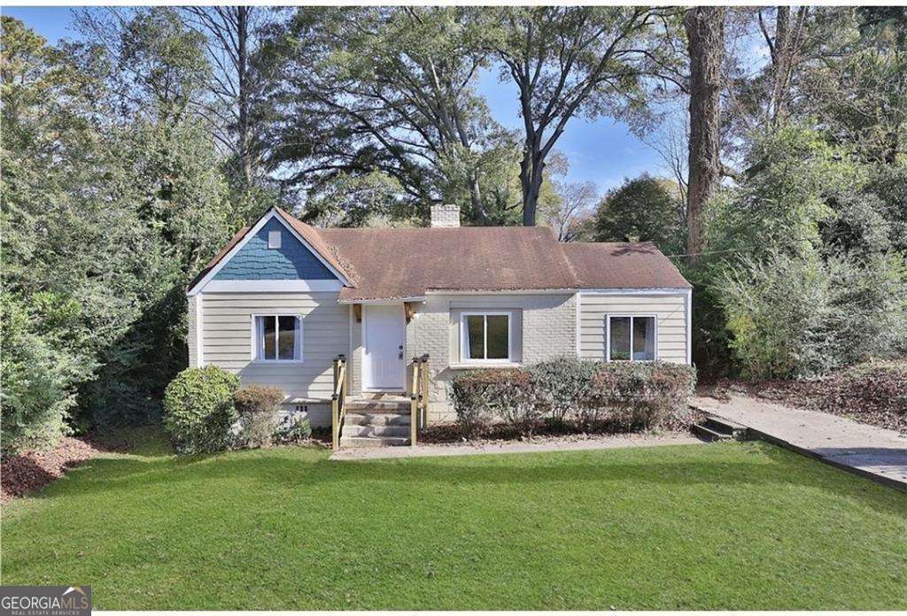 3162 Oakdale Road Hapeville, GA 30354 - Photo 1 of 26 a front view of a house with a garden