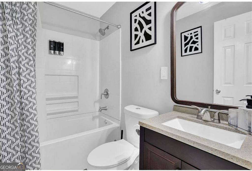 3162 Oakdale Road Hapeville, GA 30354 - Photo 17 of 26 a bathroom with a granite countertop sink mirror vanity and toilet
