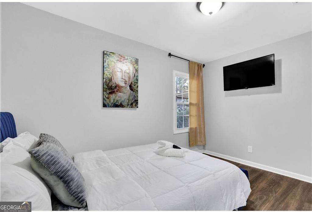 3162 Oakdale Road Hapeville, GA 30354 - Photo 18 of 26 a bedroom with a bed and a flat screen tv