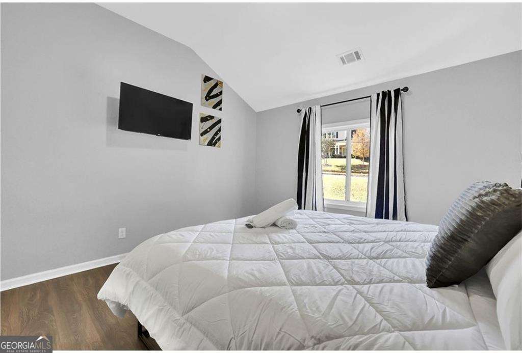 3162 Oakdale Road Hapeville, GA 30354 - Photo 19 of 26 a bedroom with a bed and a flat screen tv
