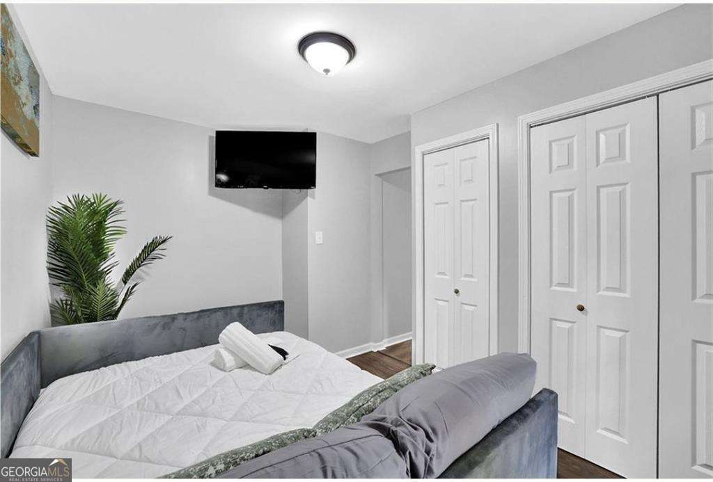 3162 Oakdale Road Hapeville, GA 30354 - Photo 20 of 26 a bedroom with a bed and a flat screen tv