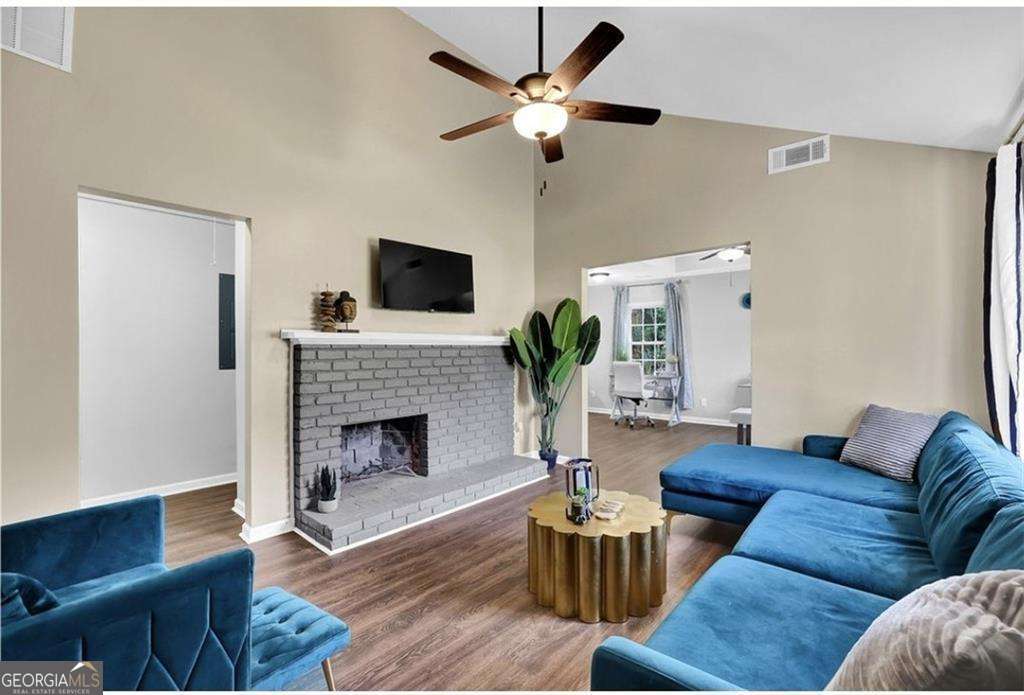 3162 Oakdale Road Hapeville, GA 30354 - Photo 2 of 26 a living room with furniture fireplace and a flat screen tv