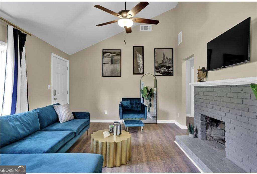 3162 Oakdale Road Hapeville, GA 30354 - Photo 3 of 26 a living room with furniture a flat screen tv and a fireplace
