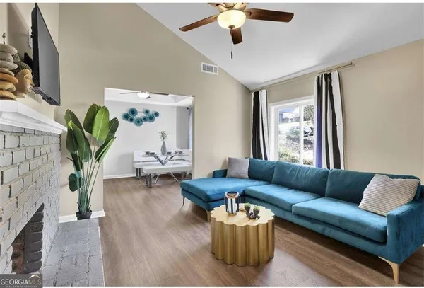 a living room with furniture and a flat screen tv