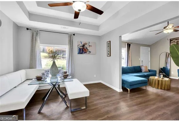 a living room with furniture and a potted plant