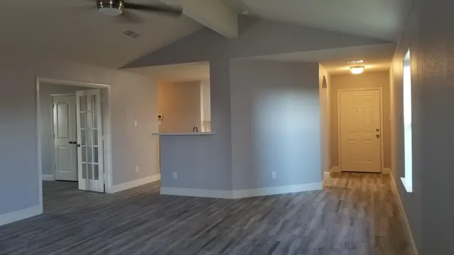 a view of hallway with wooden floor