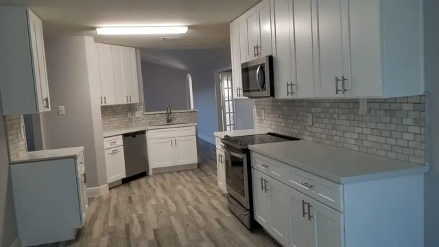 a kitchen with a sink stove and cabinets
