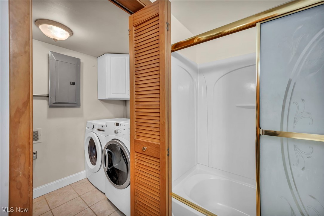 1263 Lost Nation Road, Unit 5 Willoughby, OH 44094 - Photo 23 of 26 Laundry room with light tile patterned floors, electric panel, separate washer and dryer, and cabinet space