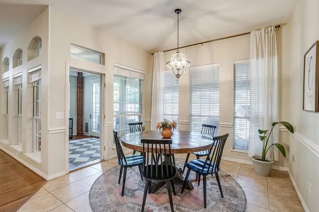 a dining room with furniture window and chandelier