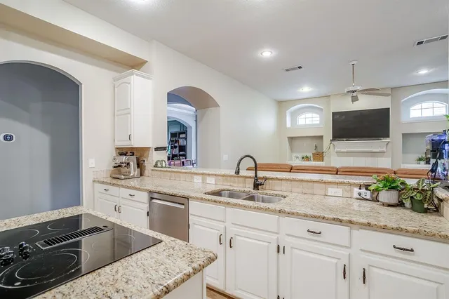a kitchen with a sink stove and cabinets