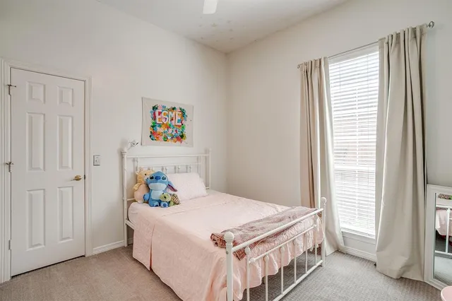 a bedroom with a bed a window and a walk in closet