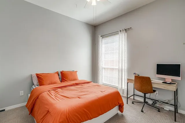 a bedroom with a bed and chair