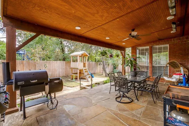 a building outdoor space with patio furniture and potted plants
