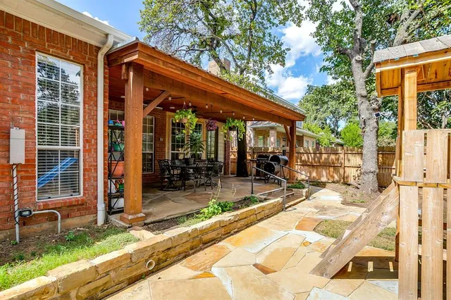 a view of a house with backyard porch and sitting area