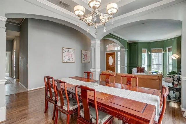 a view of a dining room with furniture wooden floor and chandelier