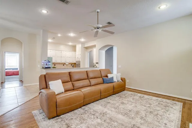 a living room with furniture and kitchen view