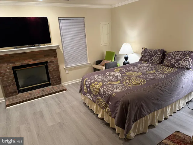 a bedroom with bed and a flat screen tv