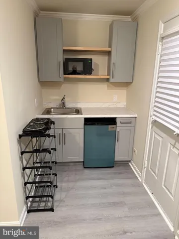 a kitchen with a sink and a stove top oven
