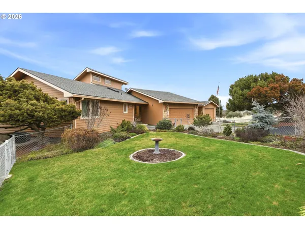 a backyard of a house with table and chairs