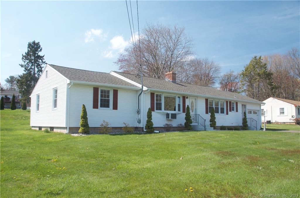 a front view of house with yard and trees