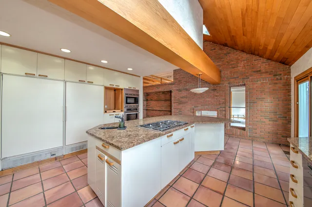 a kitchen with a stove a sink and a refrigerator