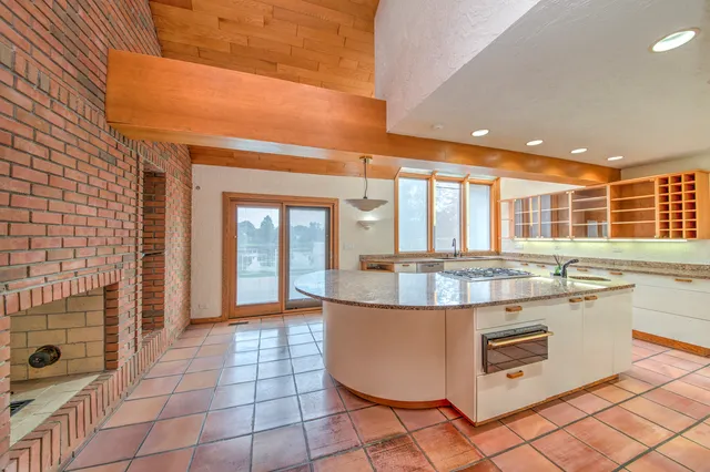 a kitchen with stainless steel appliances granite countertop a sink and cabinets
