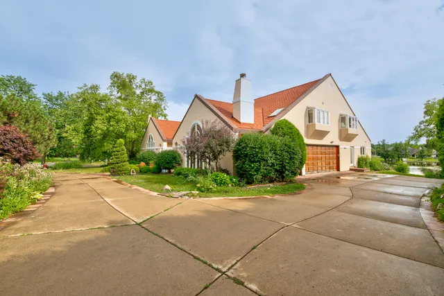 a front view of a house with a yard and a garage