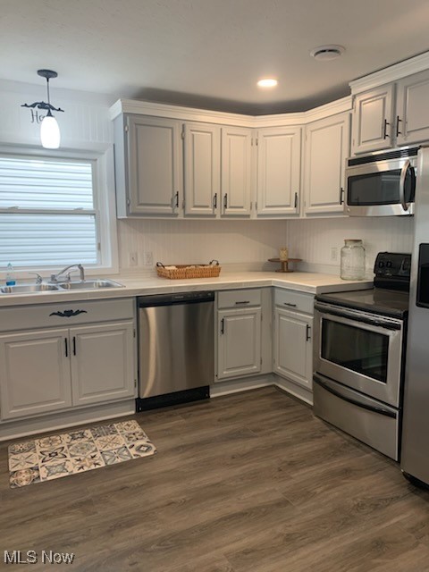 284 Altamont Road Vermilion, OH 44089 - Photo 21 of 39 Kitchen featuring dark wood-style flooring, appliances with stainless steel finishes, a sink, and light countertops