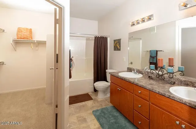 a spacious bathroom with a granite countertop sink toilet and shower