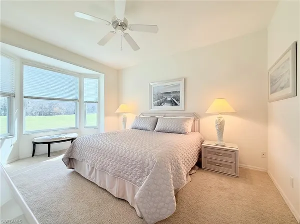 a spacious bedroom with a large bed and a window
