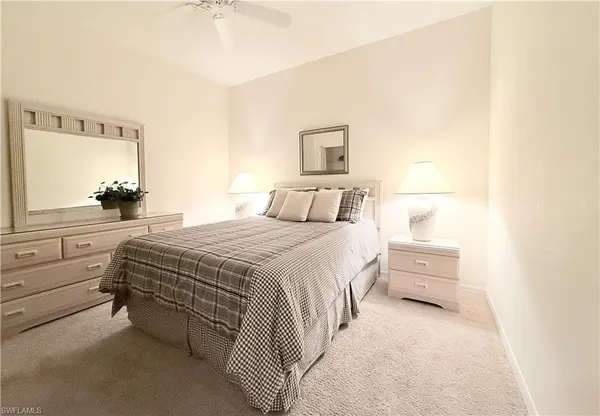 a bedroom with a bed and a view of balcony