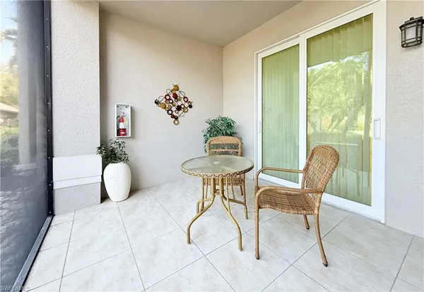 a dining room with furniture and a potted plant