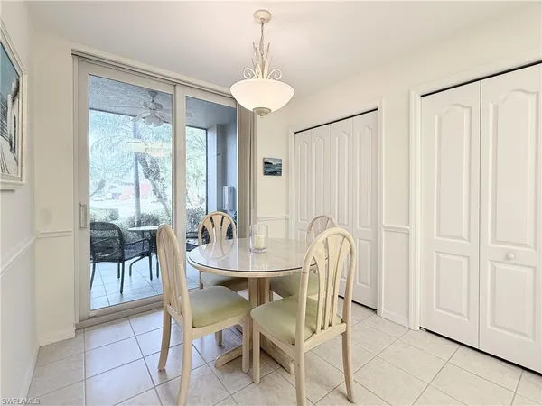 a view of a dining room with furniture and a chandelier