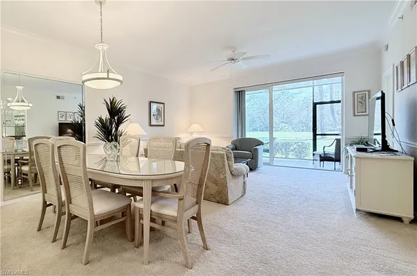 a living room with furniture and large windows