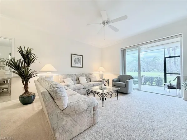a living room with furniture and a lamp