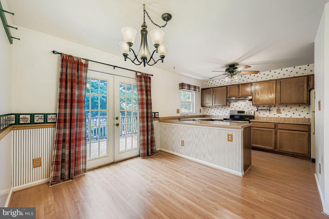 9 Bridgeview Court Baltimore, MD 21236 - Photo 6 of 27 a kitchen with stainless steel appliances granite countertop a refrigerator a sink dishwasher a stove and white cabinets with wooden floor
