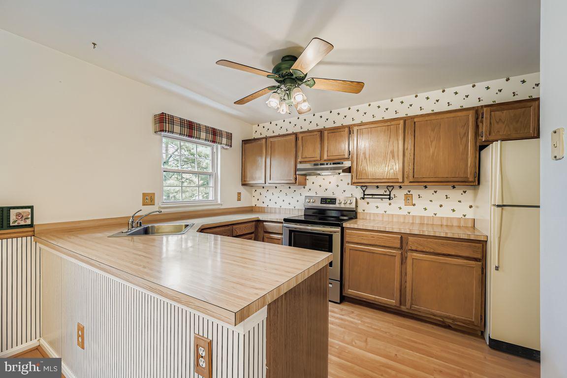 9 Bridgeview Court Baltimore, MD 21236 - Photo 7 of 27 a kitchen with kitchen island granite countertop a sink appliances cabinets and counter space
