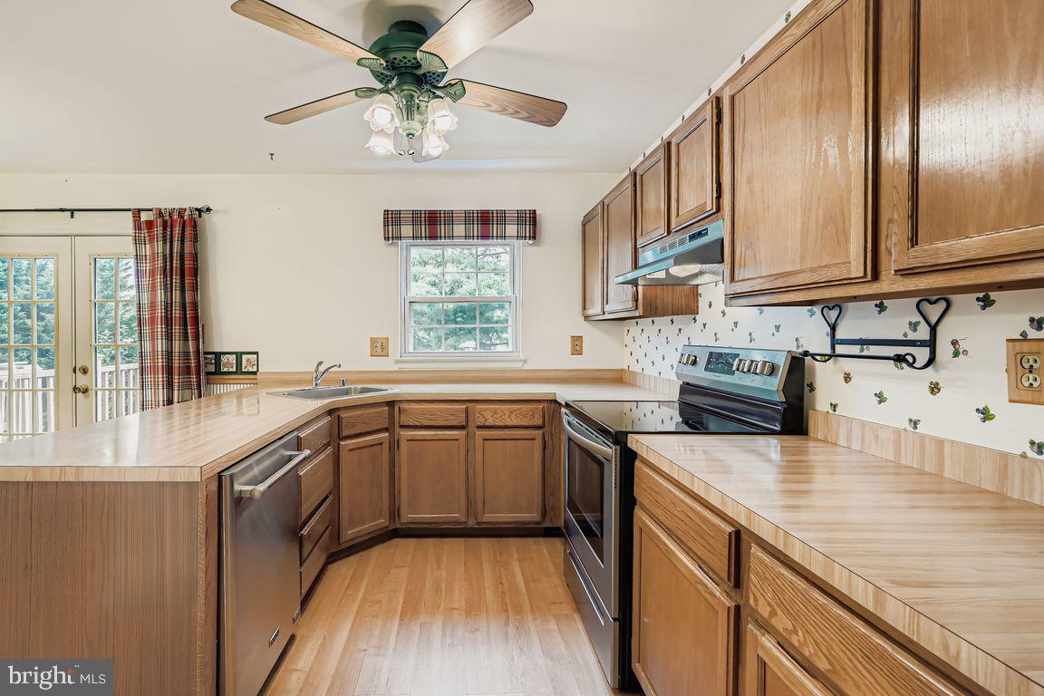 9 Bridgeview Court Baltimore, MD 21236 - Photo 8 of 27 a kitchen with stainless steel appliances granite countertop a sink a stove cabinets counter space and a window