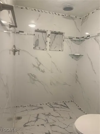 a bathroom with a toilet sink and vanity