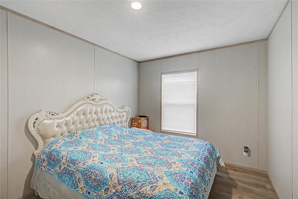 6065 Timber Trail Azle, TX 76020 - Photo 19 of 33 a bedroom with a bed and a window