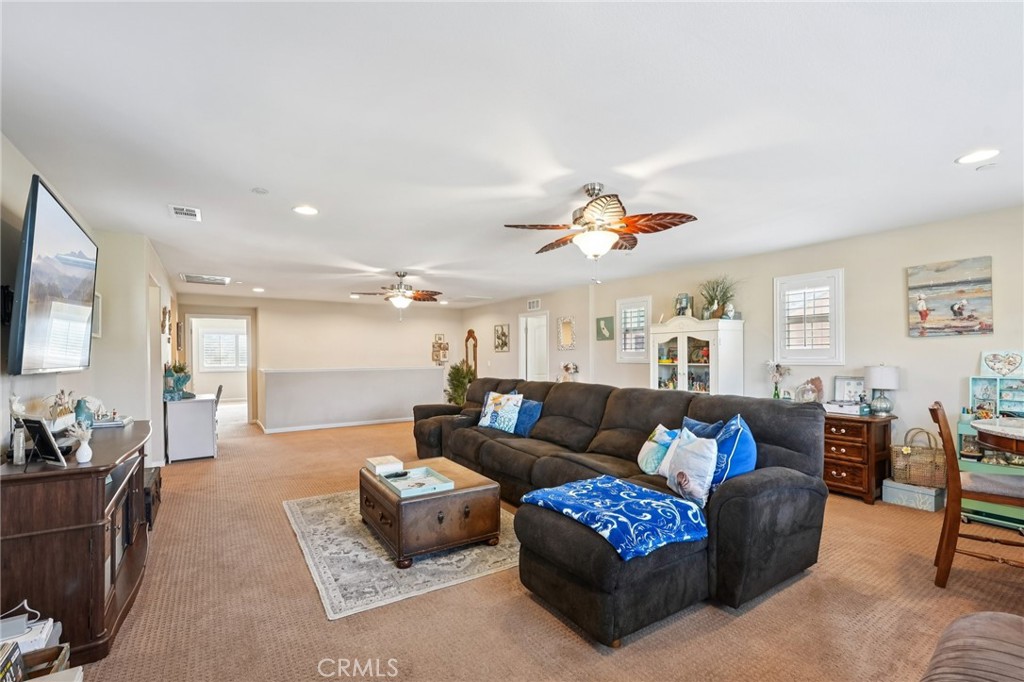 36274 Waxen Road Lake Elsinore, CA 92532 - Photo 14 of 65 a living room with furniture and a flat screen tv