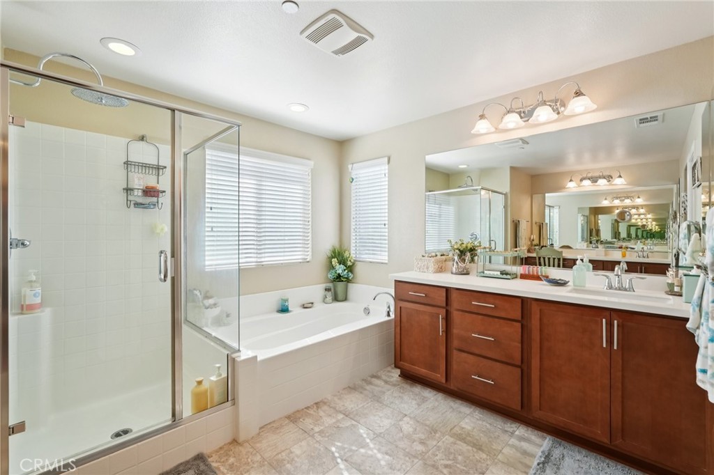 36274 Waxen Road Lake Elsinore, CA 92532 - Photo 19 of 65 a bathroom with a tub sink shower and mirror