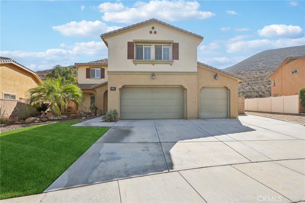 36274 Waxen Road Lake Elsinore, CA 92532 - Photo 2 of 65 a front view of a house with a yard and garage
