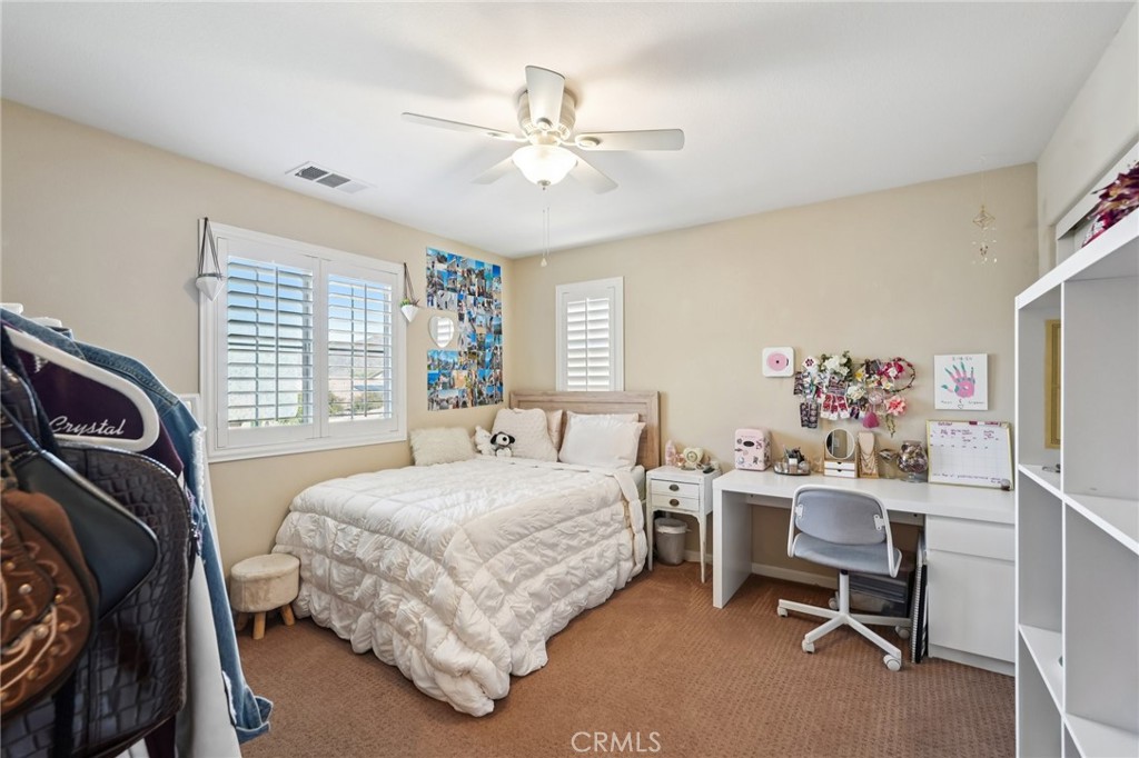 36274 Waxen Road Lake Elsinore, CA 92532 - Photo 22 of 65 a bedroom with a bed and a window